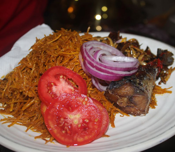 A plate of abacha with vegetables and fried fish